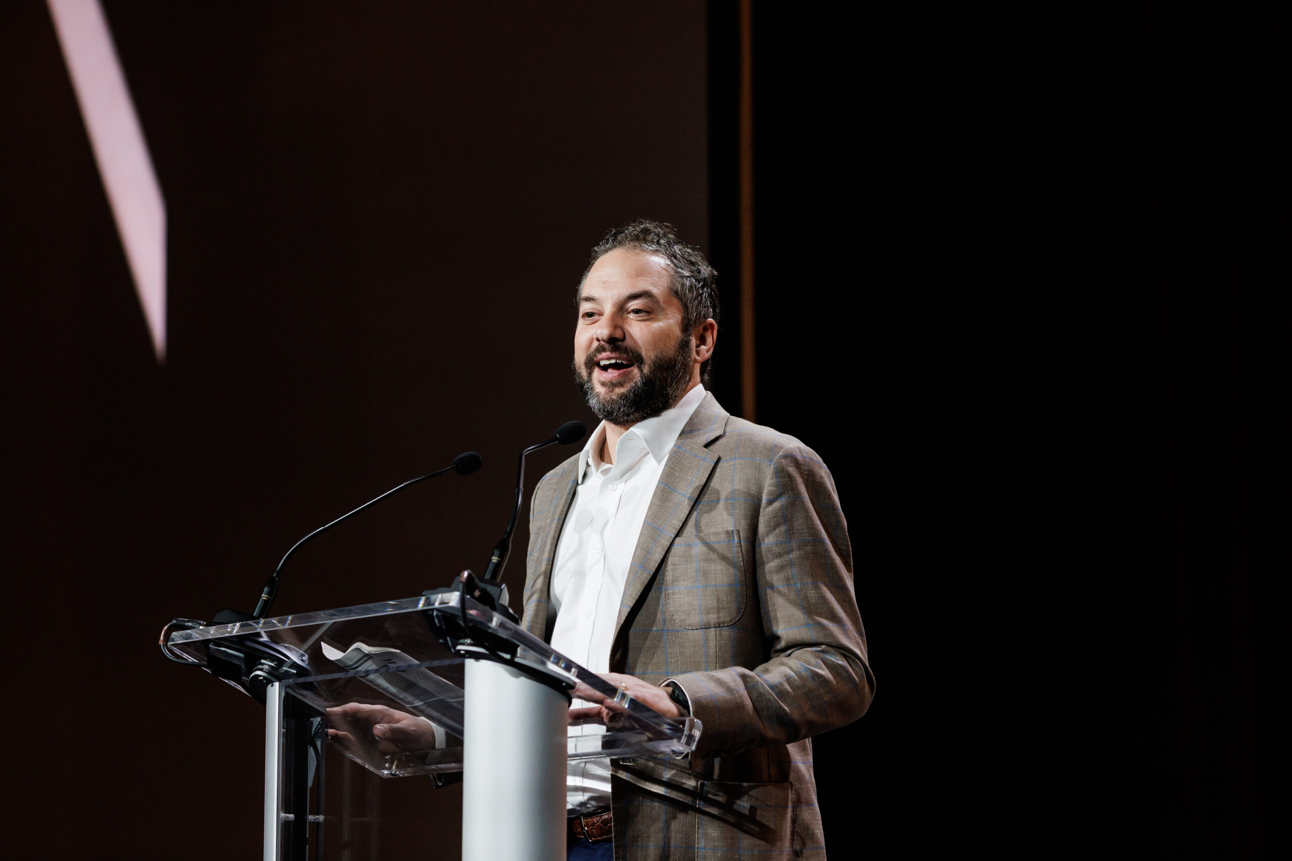Ivy Health executive speaking at a podium during a healthcare conference