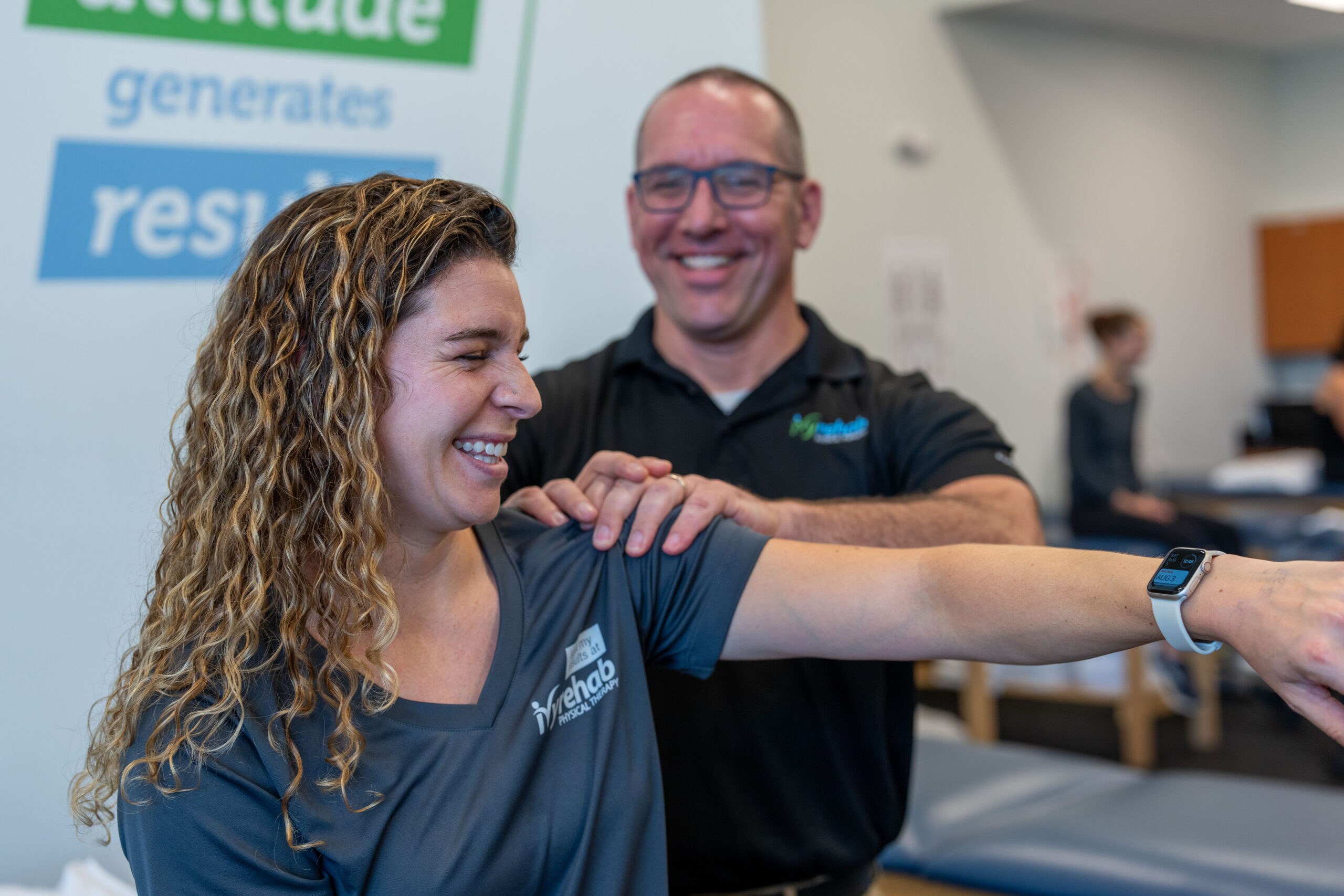 Physical therapist helping a patient improve shoulder mobility during a rehabilitation session