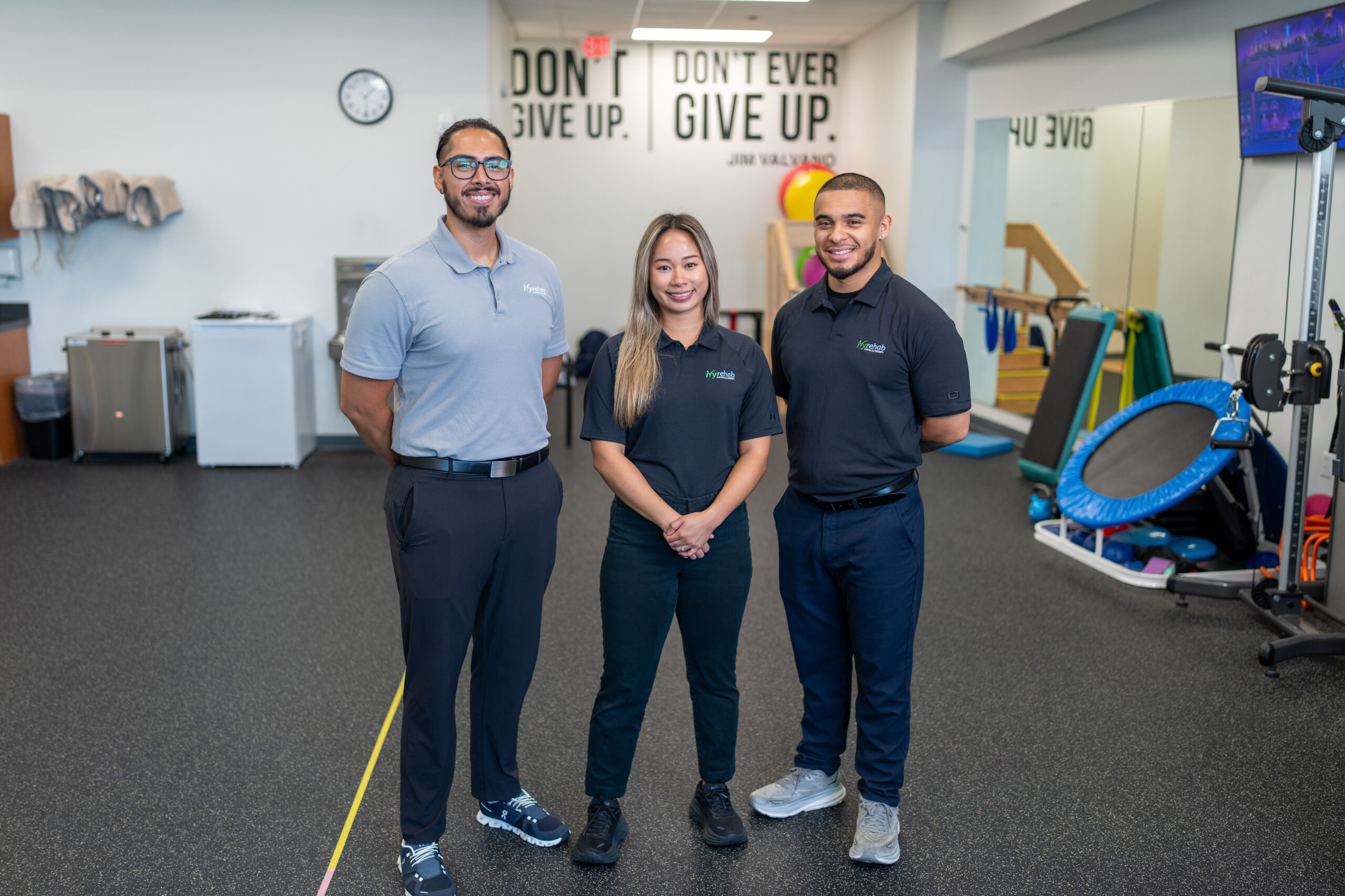 Ivy Health team members standing together in a physical therapy clinic