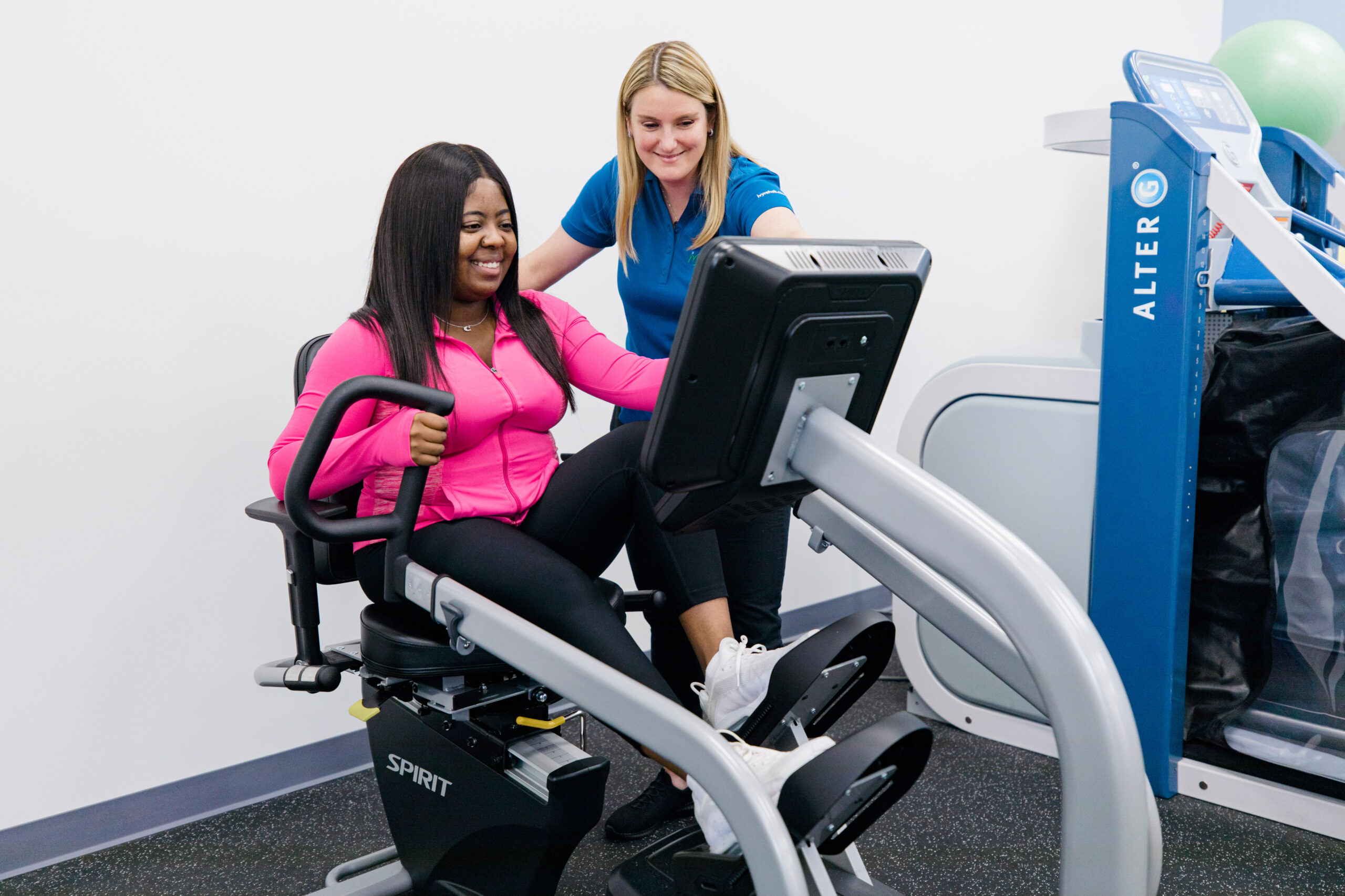 Therapist supervising a patient using an anti-gravity treadmill