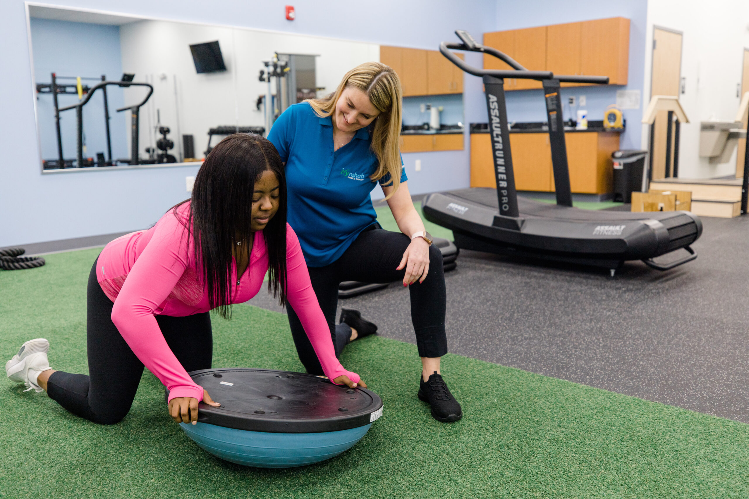 Physical therapist guiding a workers' compensation patient through balance and rehabilitation exercises