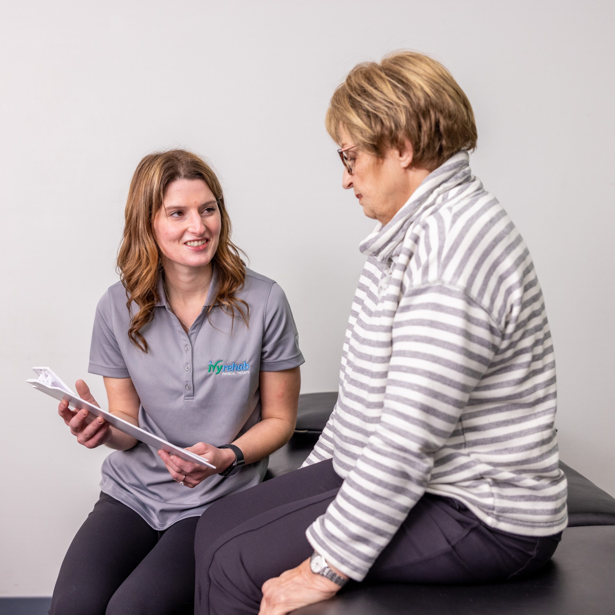 Physical therapist discussing a personalized treatment plan with a patient