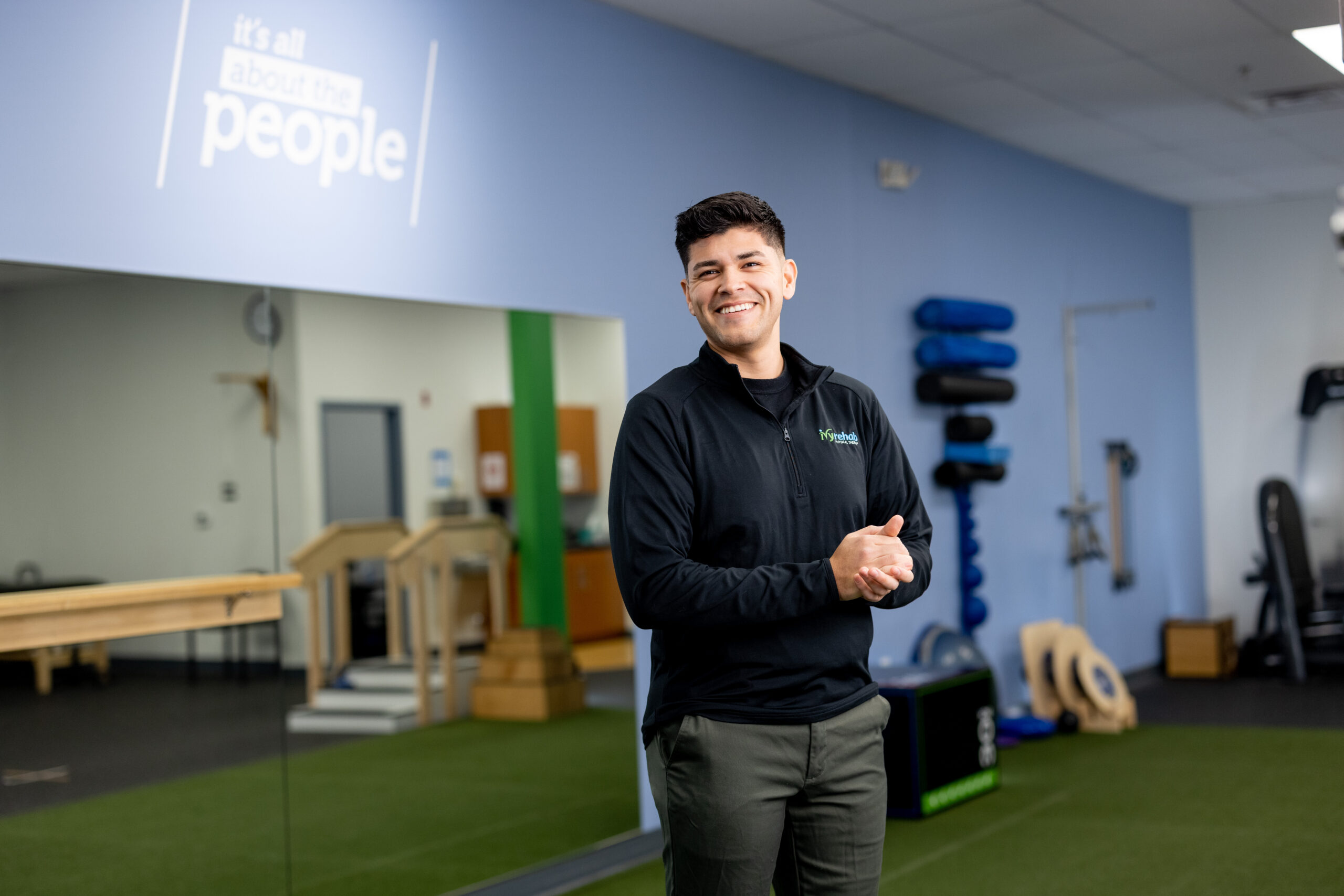 Physical therapist standing after showing office ergonomics techniques in a rehabilitation clinic