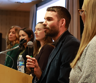 Ivy Health leader speaking into a microphone during a panel discussion