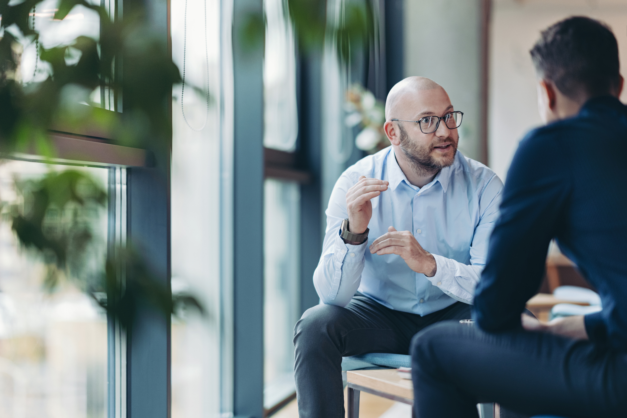 two men talking during a therapy partnership meeting